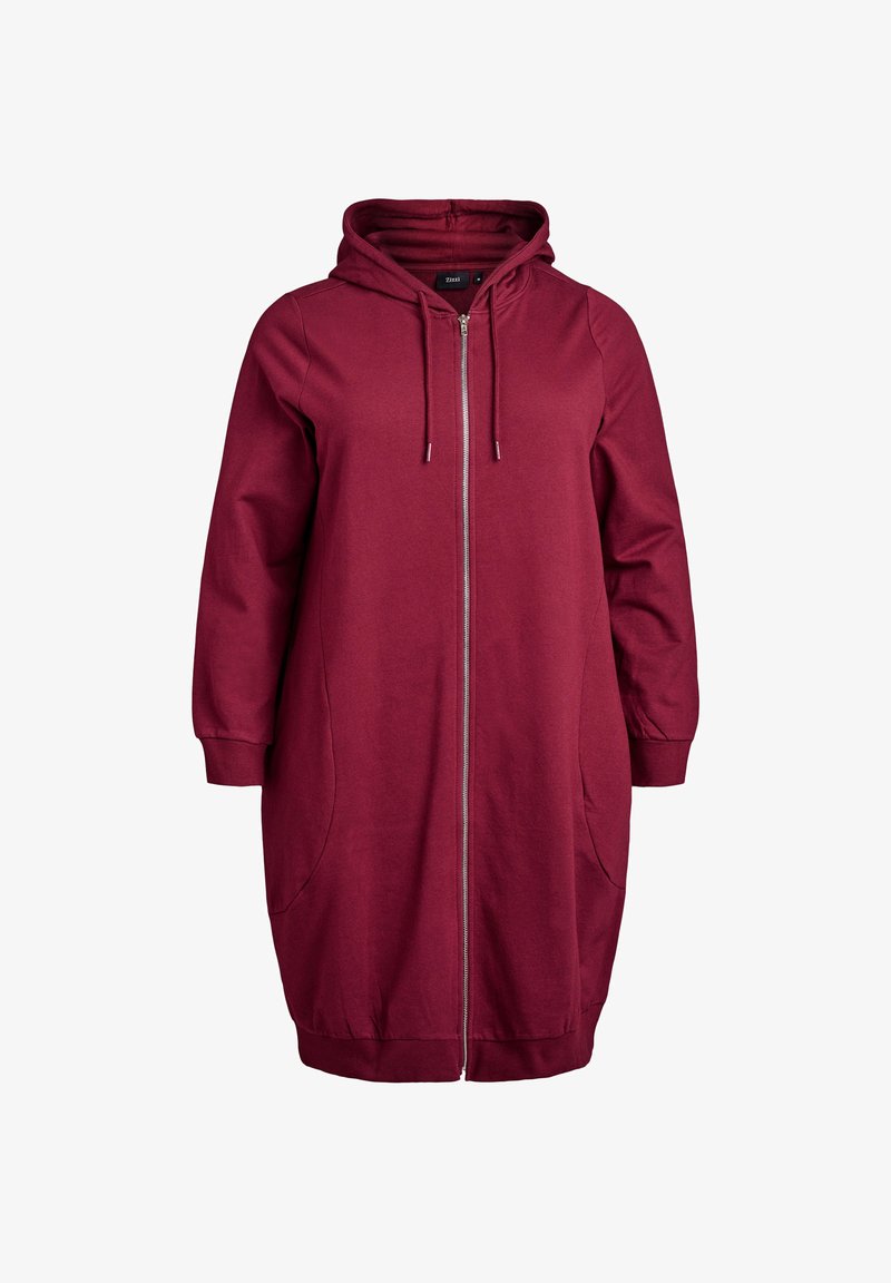 Burgundijas krāsas zip-up kapuces kleita ar lielām sānu kabatām, ar aukliņām regulējama kapuce un ribota apakšmala. Izgatavota no mīksta, izturīga auduma.
