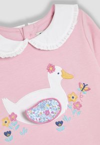 Roze katoenen jurk met een witte kraag met ruches, geborduurd eendje, bloemen en een detail met een patroon.