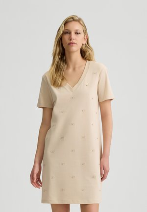 Abito beige a maniche corte con scollatura a V e ricami circolari testurizzati in tutto il capo. Tessuto morbido con una vestibilità comoda, design che arriva fino al ginocchio.
