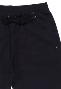 Navyblauwe sweatpants van zachte stof, met een elastische tailleband met trekkoord, zijzakken en een klein logodetail.