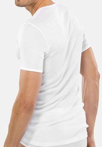 White ribbed short-sleeve t-shirt, featuring a close-fit design and smooth texture, with a crew neckline and minimal seams.