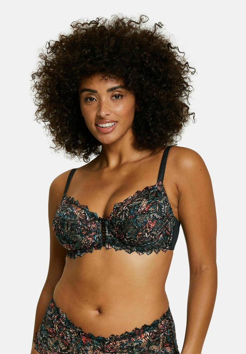 Soutien-gorge en dentelle noire avec des motifs de feuilles colorées, des bords festonnés et des bretelles ajustables. Détails comprenant un accent de nœud central.