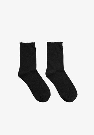 Paire de chaussettes noires mi-mollet avec des bords festonnés sur fond blanc, montrant les vues de face et de côté.