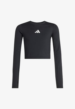 Crna dugačka majica s kratkim topom i dugim rukavima izrađena od glatkog materijala. Ima bijeli logotip na prsima i otvore za palce na manžetama.