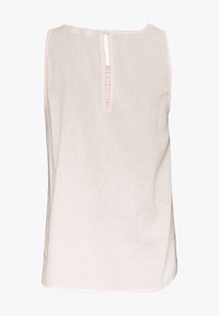 Top senza maniche di un beige chiaro realizzato in lino, con scollatura rotonda, chiusura a chiave sulla schiena con bottoni e vestibilità rilassata.