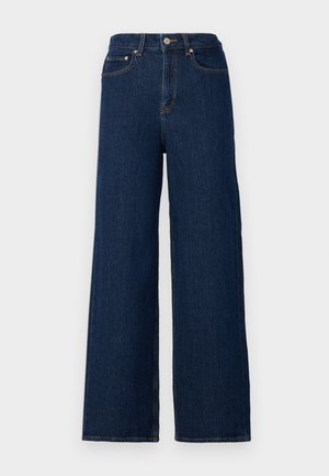 Vide benbukser laget av mørk denim, med høy midje, klassisk femlomme-design og kontrasterende sømmer langs sømmene.