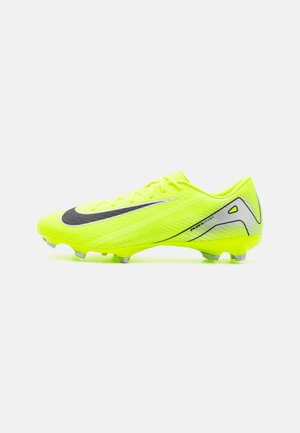 Bright yellow soccer cleat with a black swoosh, textured fabric upper, lace closure, and a streamlined shape. Features silver accents and studs.