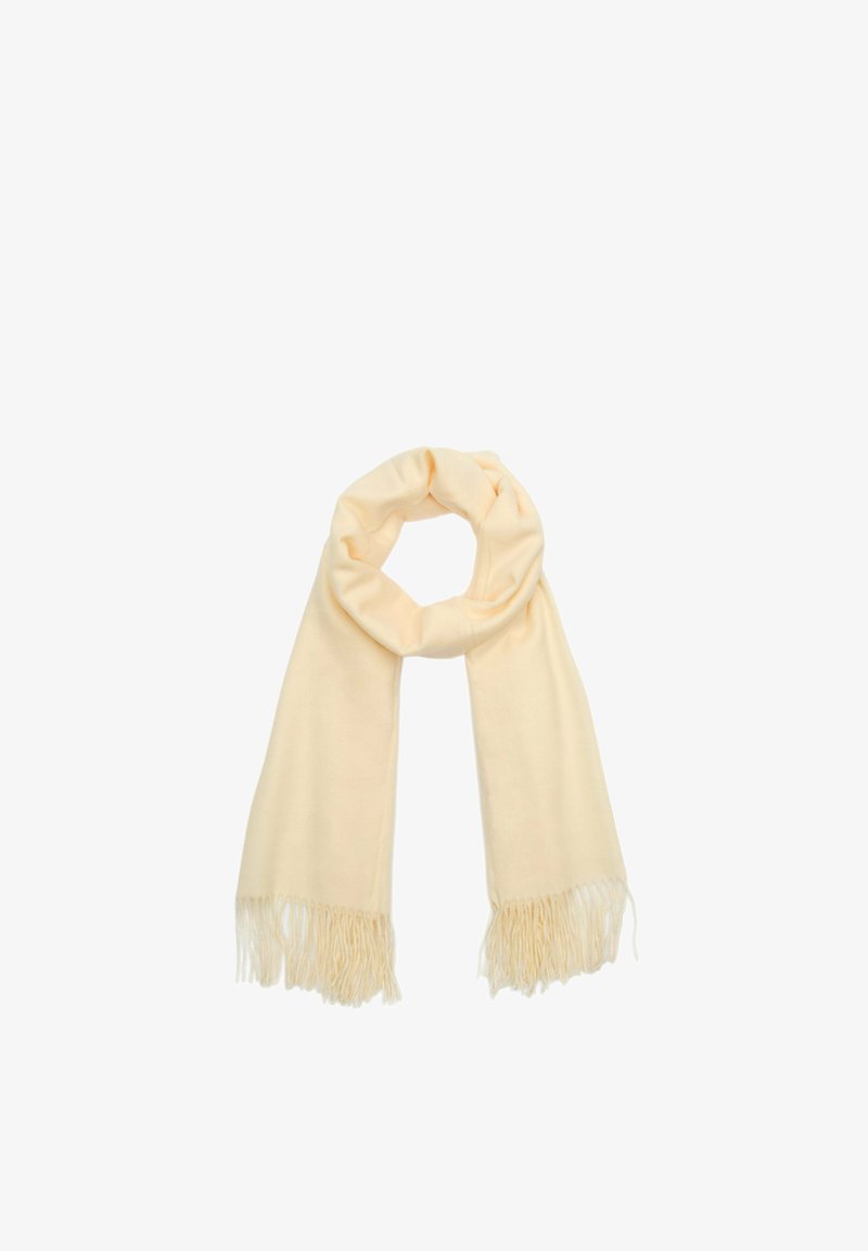 Beżowy szalik wykonany z miękkiego materiału, z frędzlami na końcach oraz luźnym, zaokrąglonym kształtem. Odpowiedni do różnych stylizacji.