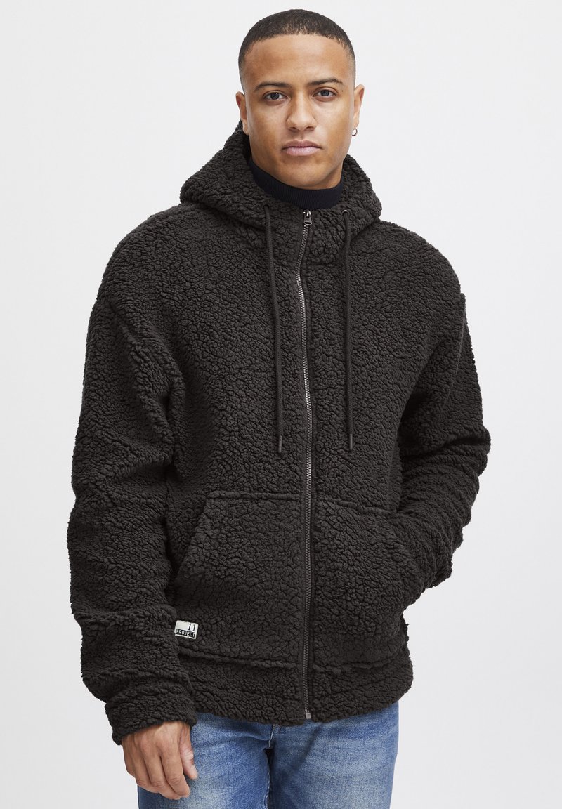 Black fleece hoodie with a textured, fuzzy surface; features a front zipper, adjustable drawstrings, and large pockets.