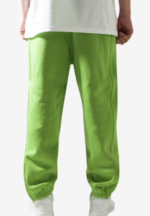 Grønne joggebukser laget av et mykt materiale, med elastisk midjebånd og mansjetter, i en avslappet passform og med minimale design detaljer.