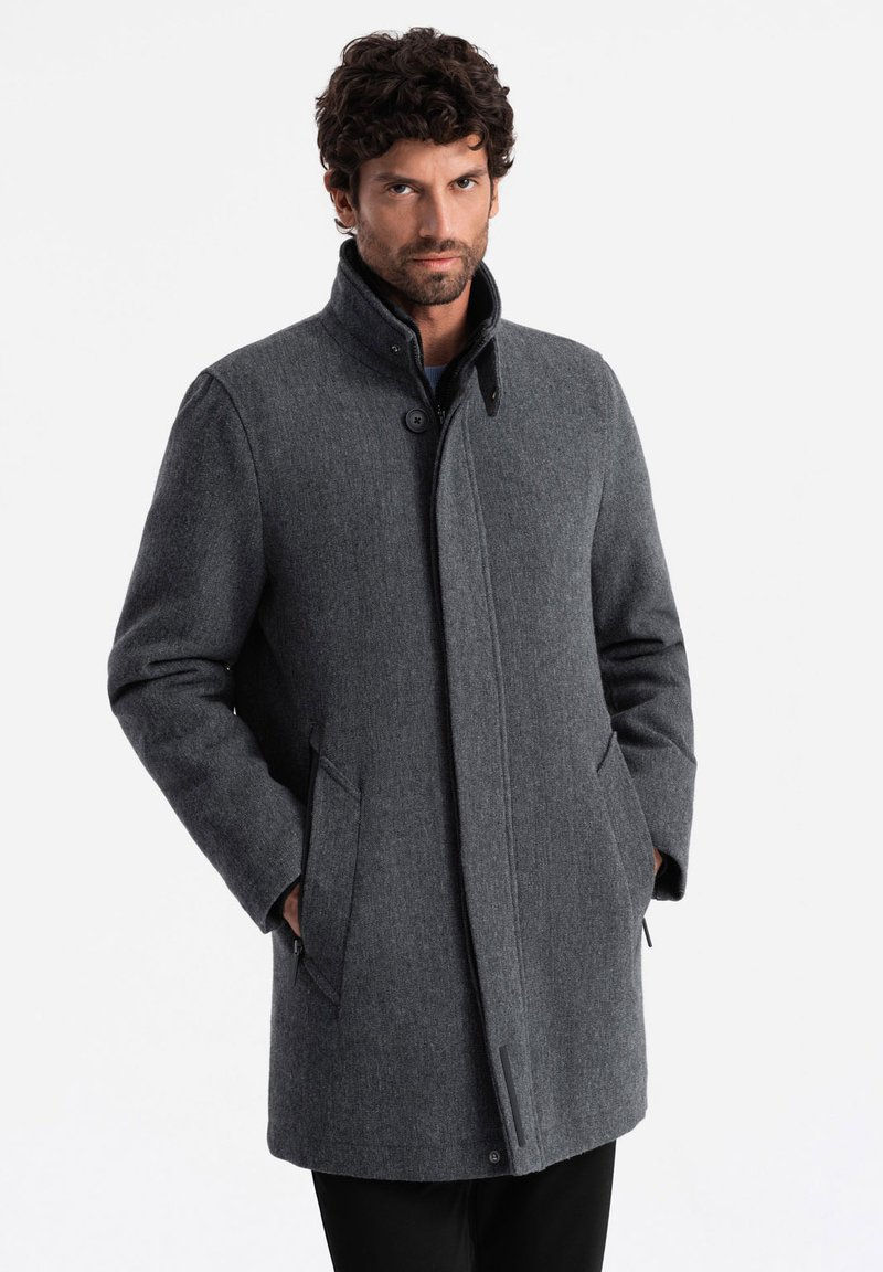 Abrigo de mezcla de lana gris para hombre con cuello alto, cierres de botones, bolsillos laterales y corte recto, que presenta una textura suave y una tela lisa.