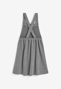 Grijze jurk met gekruiste banden, elastische taille en uitlopende rok. Gemaakt van zachte stof, met een gladde textuur en een eenvoudig ontwerp.