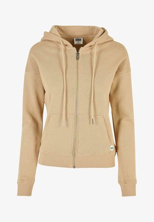 Beige zip-up hoodie with a drawstring hood, ribbed cuffs and hem, and front pocket. Features silver zipper and small logo detail at the hem.