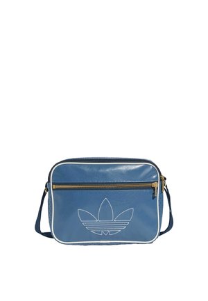 Niebieska prostokątna skórzana torba na ramię z białą lamówką, przednią kieszenią na zamek oraz wyszywanym logo Adidas trefoil.