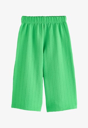 Pantaloni verde brillante a gamba larga con motivo a righe verticali strutturate e vita elasticizzata, mostrati stesi su uno sfondo bianco.