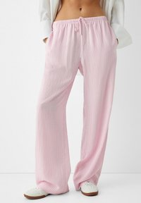 Light pink striped wide-leg pants with an elastic waistband and drawstring. Made from a soft, lightweight fabric. Two side pockets.