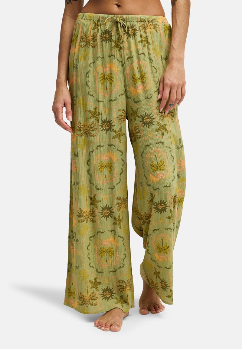 Ανοιχτό πράσινο παντελόνι με φαρδιά μπατζάκια από υφασμάτινη υφή, διακοσμημένο με πολύχρωμο τροπικό μοτίβο με φοίνικες και αστέρια. Ρυθμιζόμενη ελαστική μέση με κορδόνι.