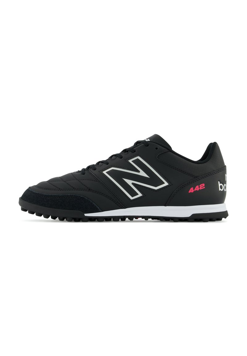 Black athletic shoe with a textured leather upper, silver logo, white midsole, and black rubber tread. Features pink accents and laces.
