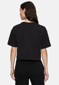 Cropped black t-shirt with short sleeves, cotton material, relaxed fit, plain design, featuring a crew neck and no visible logos or patterns.