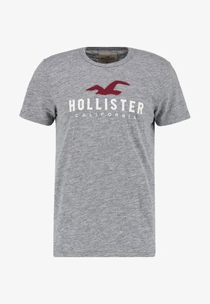 Grijs katoenen T-shirt met korte mouwen, voorzien van een bordeauxrode logo en de tekst "HOLLISTER CALIFORNIA" in wit aan de voorkant. Klassiek ontwerp met ronde hals.