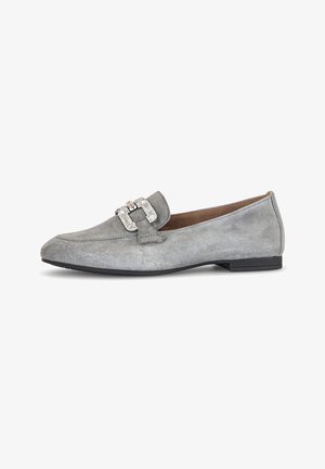 Mocassin plat en daim gris avec un petit talon noir et un détail de boucle argentée sur le dessus, présenté de profil intérieur sur un fond blanc.