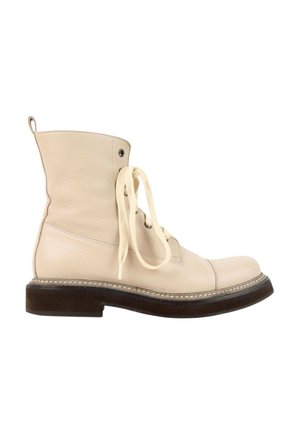 Cream-colored leather ankle boot with laces and a dark brown thick sole shown from the side on a white background.