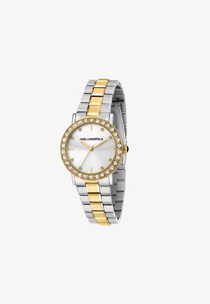 Sølv- og guldur med en rund skive, funkende krystalkrans og et metalarmbånd med skiftende guld- og sølvled.