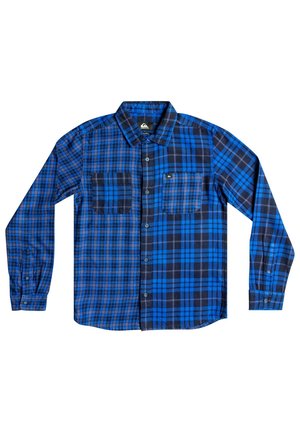 Chemise à manches longues avec un motif à carreaux bleu et noir, deux poches avant et un col boutonné.