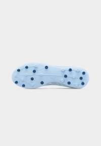 Sole of a light blue soccer cleat with dark blue studs evenly spaced for traction on grass surfaces.