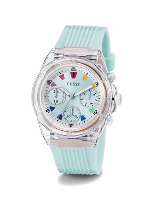 Montre Guess transparente avec un bracelet en silicone bleu clair. Présente un cadran bleu pastel, trois sous-cadrans et des marqueurs d'heure colorés.
