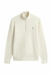 Weißer Pullover mit hohem Kragen, Halsnaht mit Viertelreißverschluss, strukturiertem Strickmuster und gerippten Bündchen. Kleines Logo auf der Brust.