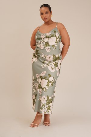 Floral maxi dress in green with pink and white flowers. Features a cowl neck and thin straps, made from a smooth, lightweight material.
