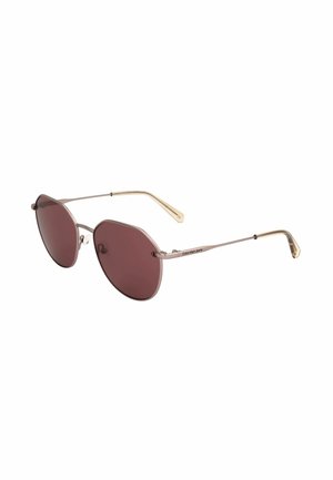 Occhiali da sole rotondi con lenti marroni, sottili montature in metallo dorato e aste beige, logo Calvin Klein Jeans sulla stanghetta.