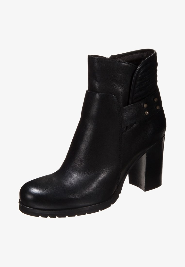 Black leather ankle boot with a thick heel, side stitching, and vertical ribbed accents. Features decorative metal studs on the side.