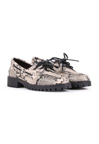 Snakeskin-patterned shoes with a beige and black color scheme, featuring black laces and a thick, textured black rubber sole.