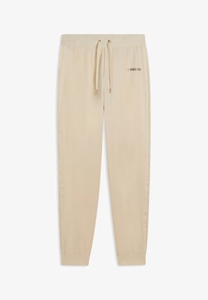 Pantaloni da jogging beige realizzati in tessuto morbido, dotati di una vita elastica con cordoncino, caviglie a costina e un logo discreto sulla coscia.
