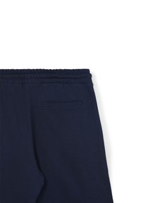 I pantaloni della tuta blu navy presentano una cintura elastica, una texture morbida e una tasca posteriore singola con un design di apertura elegante.