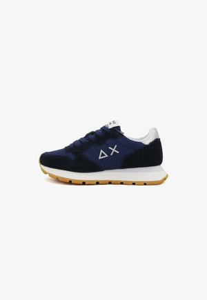 Navy blue sneakers with suede and mesh materials, white midsole, rubber outsole, and contrasting logo accents. Features round laces.