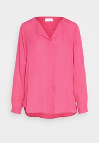 Chemisier rose à manches longues avec un col en V et une texture légère et lisse. Présente une coupe décontractée et un ourlet légèrement arrondi.