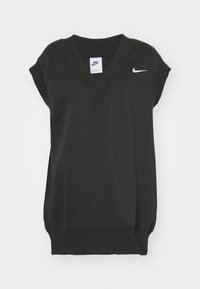 Svart ärmlös topp i bomull med V-ringning, ribbad halsringning och en liten vit Nike-logotyp på bröstet. Slät textur.