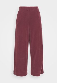 Wijde broek van zachte bordeauxrode stof. Voorzien van een elastische tailleband en een gladde textuur, geschikt voor casual draag. 