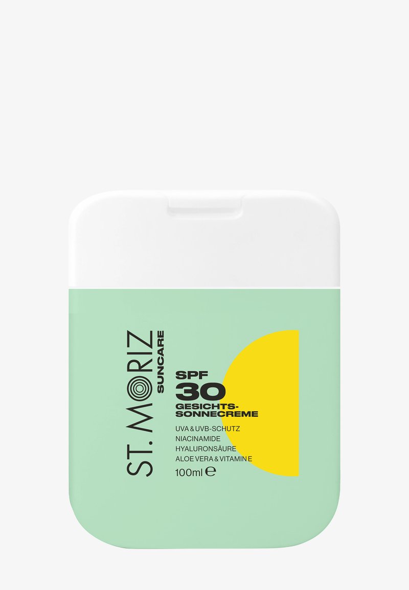 Flacon rectangulaire compact de crème solaire visage St. Moriz SPF 30 avec étiquette verte et graphique de soleil jaune, volume 100 ml.