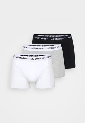 Trois paires de boxers en blanc, gris et noir avec des bandes élastiques arborant le logo "JJ Studios" en noir.
