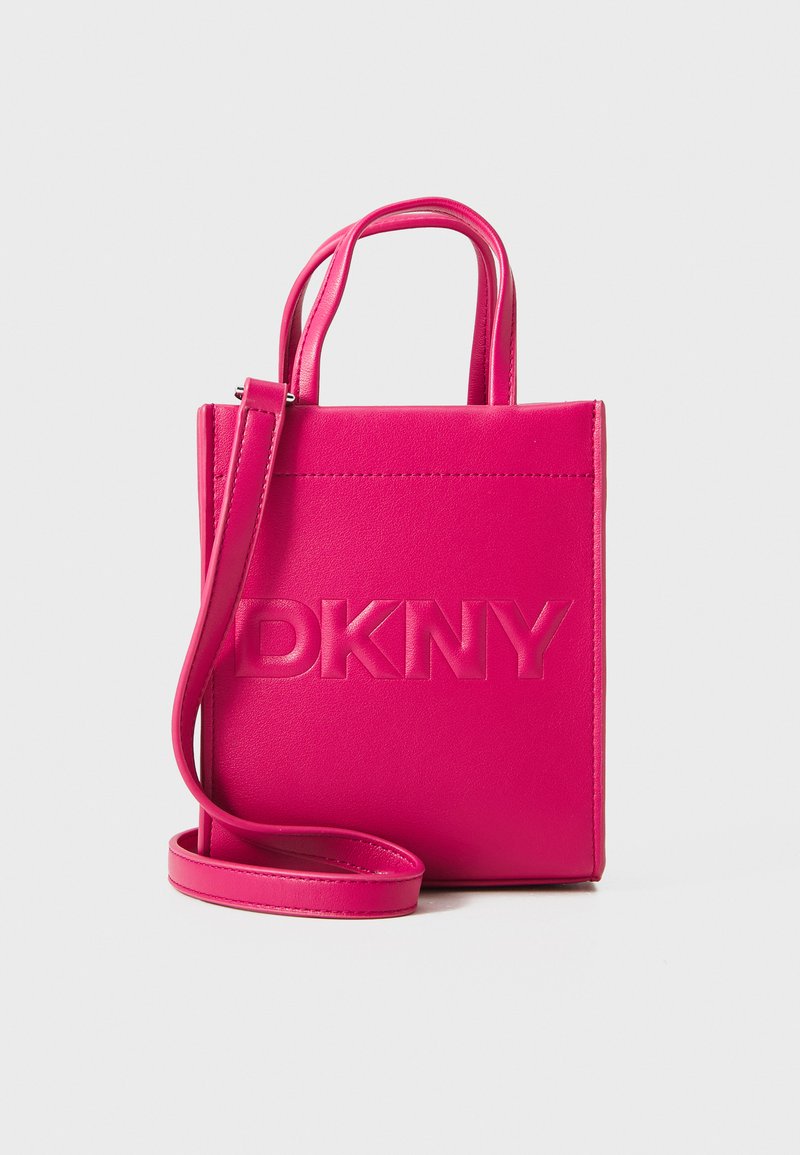 Ružová kožená kabelka so štruktúrovaným dizajnom, s embosovaným logom "DKNY" vpredu, vrchnými uchami a odnímateľným ramenným popruhom.