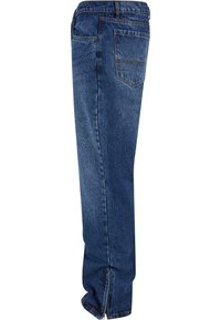 Donkerblauwe denim jeans met een rechte snit, voorzien van een ritssluiting bij de enkel en een klassieke vijf-pocketontwerp. Zware stof textuur.