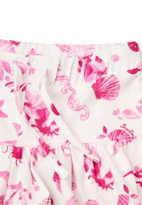 Katoenen rok met een elastische tailleband, uitgevoerd in een roze zeethema op een witte achtergrond. Inclusief een trekkoorddetail.
