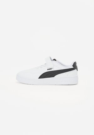Zapatillas blancas con una correa de velcro, que presentan un logo negro de Puma y un acento negro. Tienen una textura suave y un diseño de caña baja.