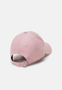 Pink cotton baseball cap with a curved brim and adjustable metal strap at the back. Features stitched detailing and ventilation holes.