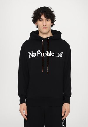 Black hooded sweatshirt featuring "No Problemo" in white text. Red and white striped drawstrings, with ribbed cuffs and hem. Smooth texture.