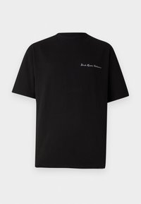 Black cotton t-shirt with short sleeves and a crew neck. Features “Don’t Fear Critics” embroidered in white on the left chest.